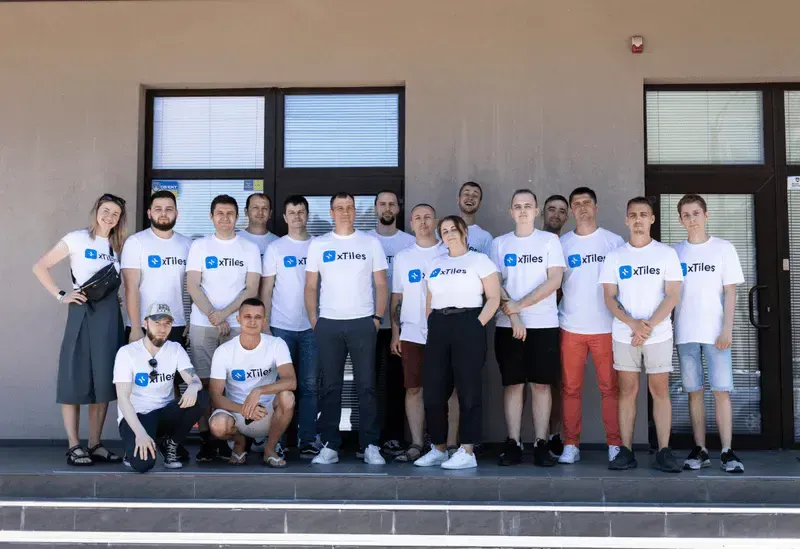 The xTiles team lined up outside the office in matching xTiles T-shirts